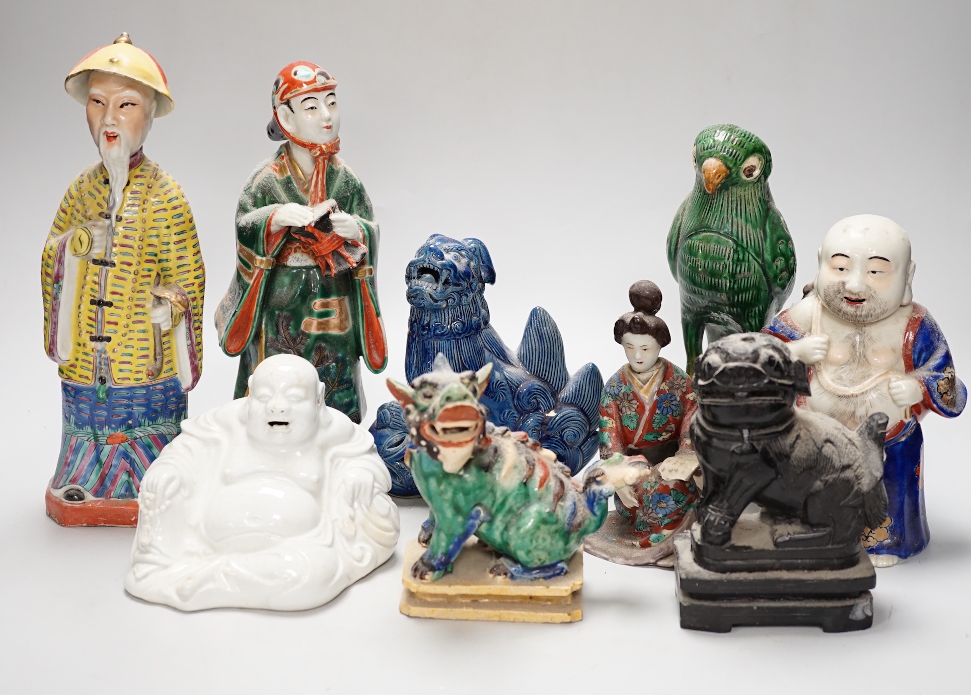 A group of assorted Chinese and Japanese pottery and porcelain figures, 19th/20th century, tallest 26cm high